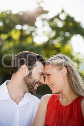 Couple face to face in park on a sunny day