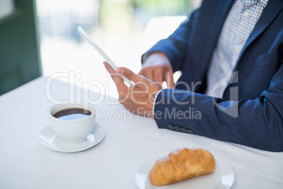 Businessman using digital tablet in a restaurant