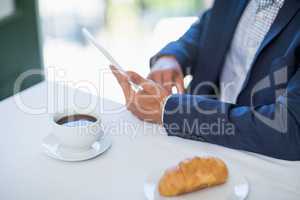 Businessman using digital tablet in a restaurant