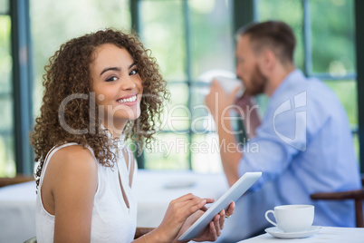 Woman holding digital tablet in a restaurant