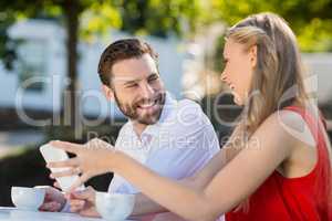 Couple using mobile phone in a restaurant