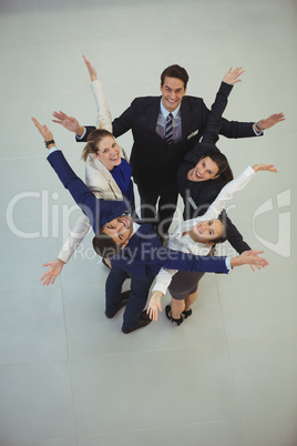 Businesspeople standing together with arms outstretched