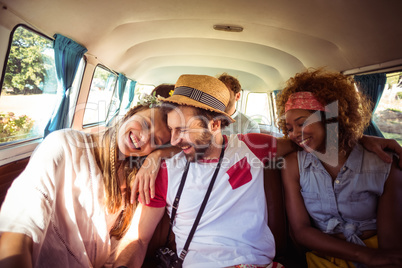 Group of friends having fun in campervan