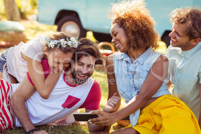 Group of happy friend using mobile phone