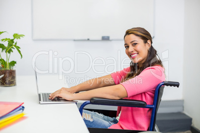 Portrait of disabled executive working on laptop in office