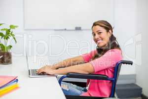 Portrait of disabled executive working on laptop in office