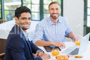 Happy businessman and colleague in a restaurant
