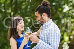 Couple toasting glasses of wine in a restaurant