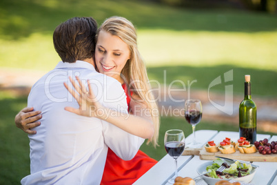 Woman looking at her ring while hugging the man