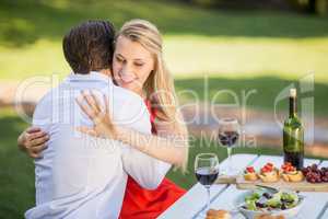 Woman looking at her ring while hugging the man