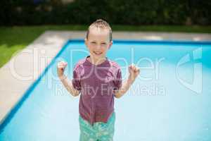 Smiling girl standing near swimming pool