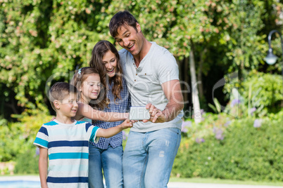 Happy family taking a selfie on mobile phone