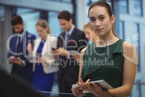 Businesswoman holding digital tablet at office