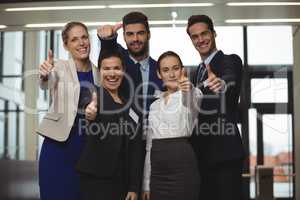 Successful businesspeople showing thumb up sign