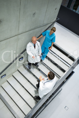 High angle view of doctors and surgeons interacting with each other on staircase