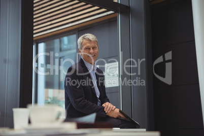 Portrait of smiling businessman holding clipboard