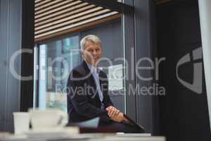 Portrait of smiling businessman holding clipboard