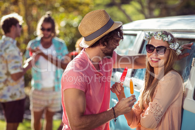 Couple enjoying and eating ice lolly