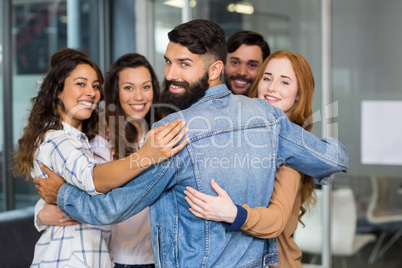 Portrait of smiling executives forming circle in office