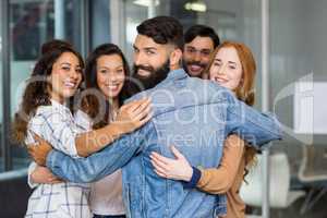 Portrait of smiling executives forming circle in office