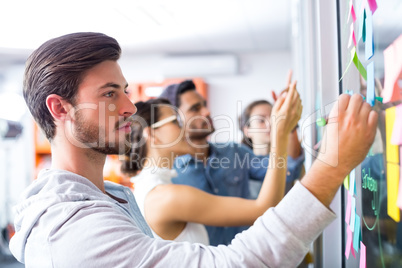 Male executive writing on sticky notes