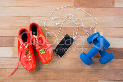 Mobile phone with headphones, shoes and dumbbells