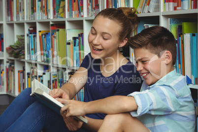 School kids reading books in library at school