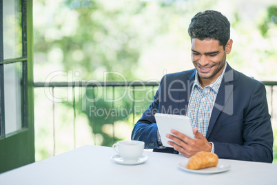 Smiling businessman using digital tablet