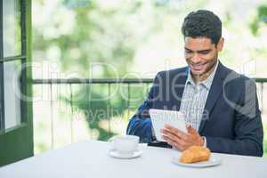 Smiling businessman using digital tablet