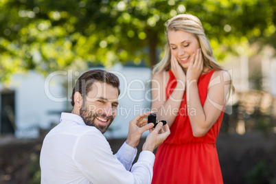 Man proposing a woman with a ring on his knee