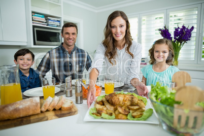 Portrait of smiling family having lunch together on dining table