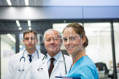 Smiling doctors and surgeon standing together in hospital Smiling doctors and surgeon standing together in hospital