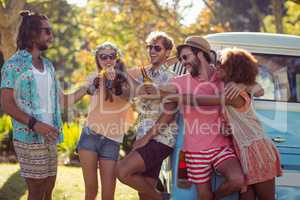 Group of friends toasting beer bottles