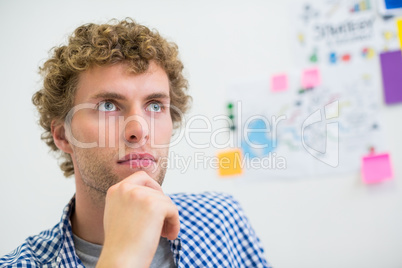 Thoughtful executive sitting with hand on chin