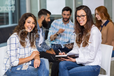 Portrait of female executives sitting in meeting