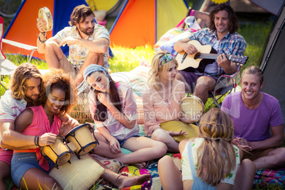 Group of friends having fun together at campsite