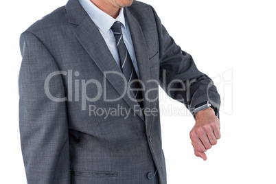 Mid section of businessman checking his smart watch