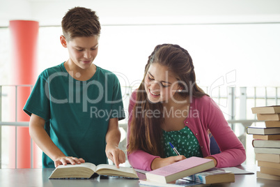 School kids doing homework in library at school