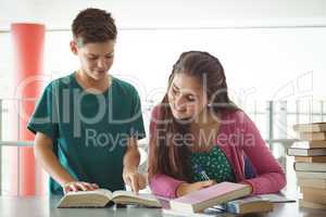 School kids doing homework in library at school