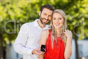 Happy couple holding ring standing in the restaurant