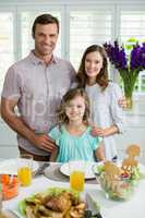 Portrait of smiling family having lunch together on dining table