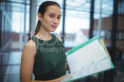 Businesswoman holding files at office