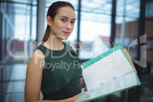 Businesswoman holding files at office