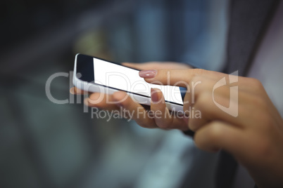 Hand of businesswoman using mobile phone