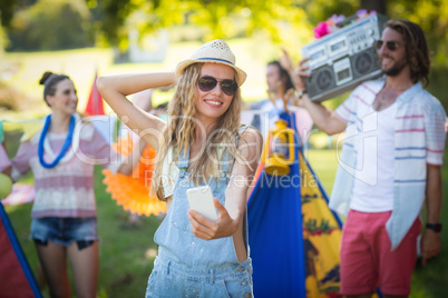 Woman taking selfie at campsite