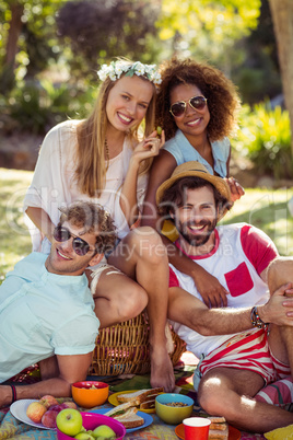 Friends having picnic in park