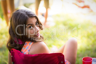 Woman sitting on chair in park