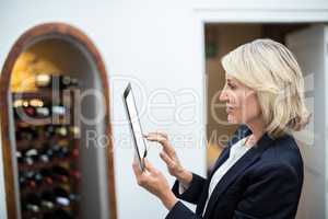 Businesswoman using digital tablet in a restaurant