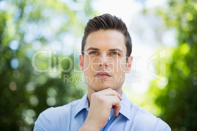 Thoughtful man in park on a sunny day