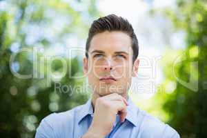 Thoughtful man in park on a sunny day